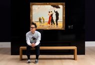Blink-182's Mark Hoppus Besides Banksy's "Crude Oil (Vettriano)" In Sotheby's London Galleries (Image via Getty/Tristan Fewings)